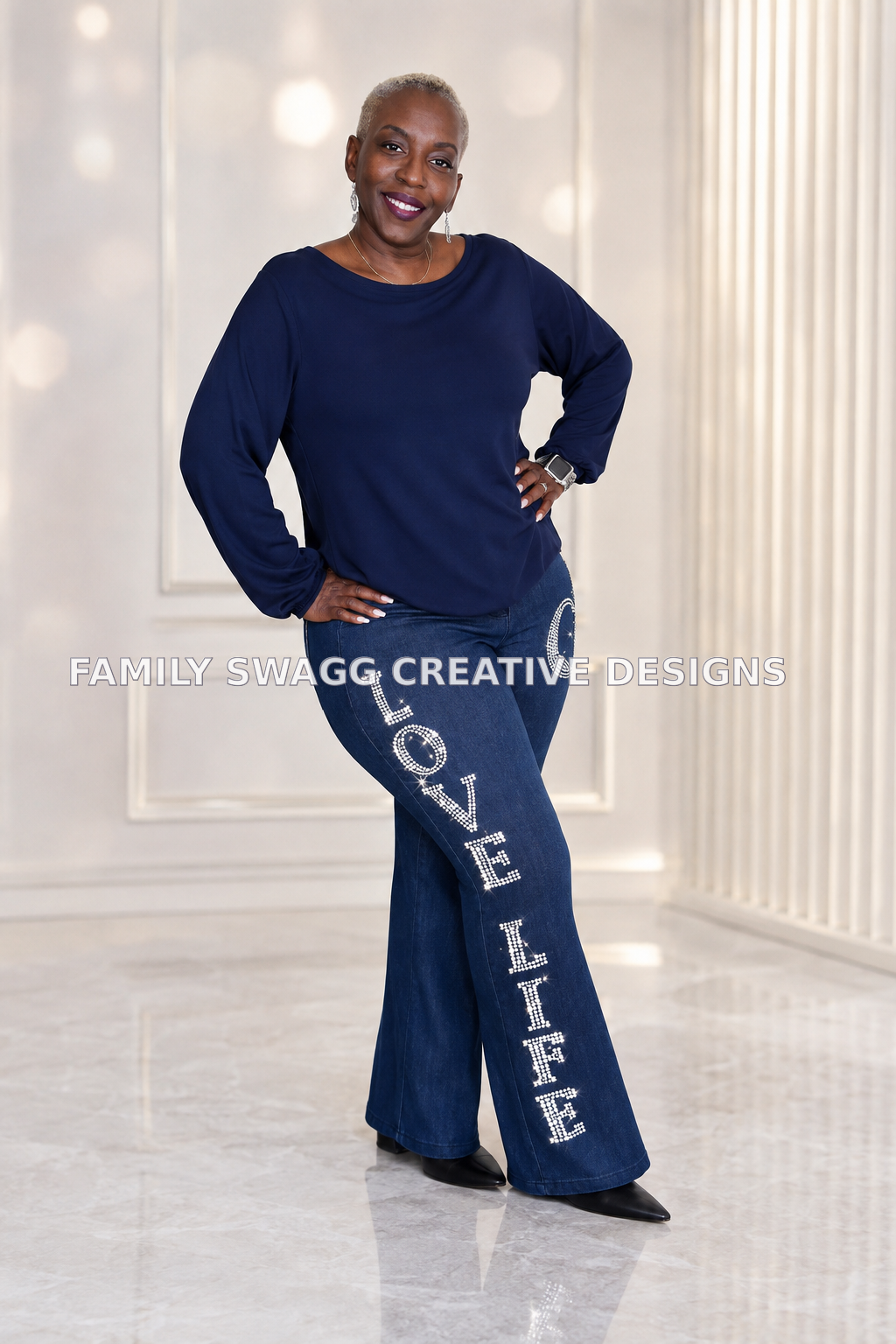 African-American woman modeling customized dark-denim LOVE LIFE rhinestone bling pants in a bright luxury studio