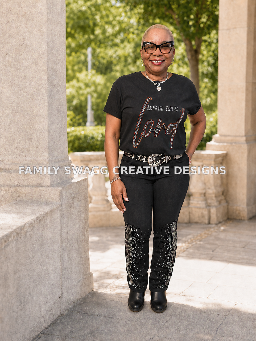 Model wearing a black Use Me Lord rhinestone shirt with matching rhinestone pants