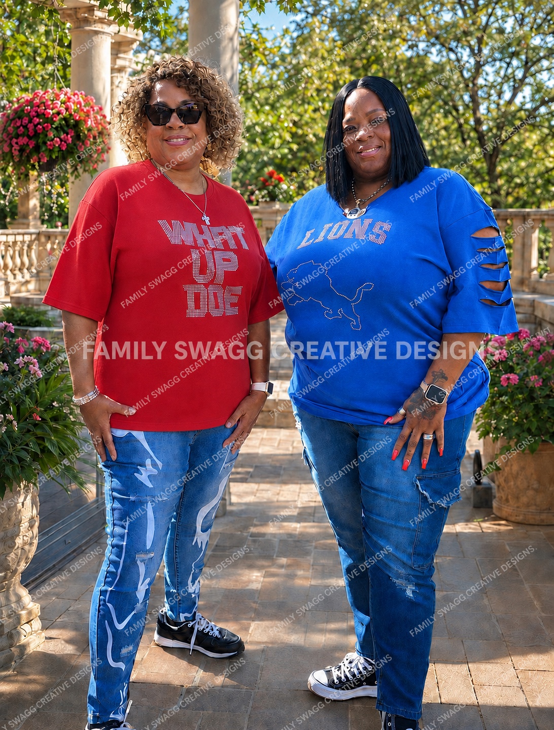 Two women modeling red WHAT UP DOE and royal-blue Lions rhinestone shirts outdoors